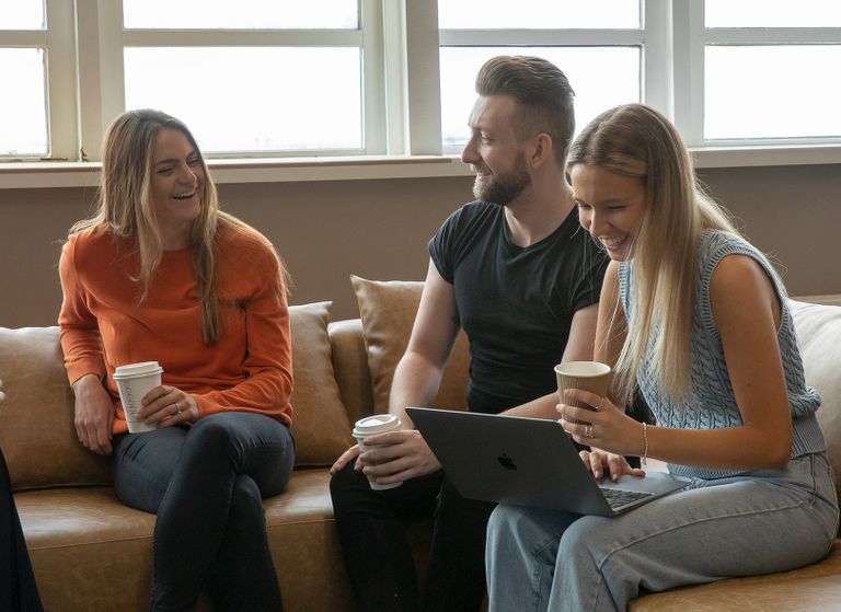 Colleagues drinking coffee and laughing